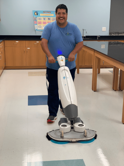 EMD employee cleaning floor